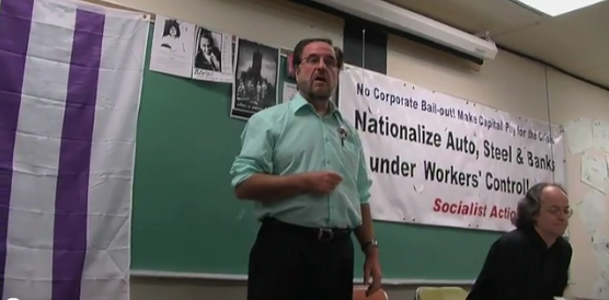 International Socialist, and prominent con-artist, Kevin Annett (notice what it says on the banner)