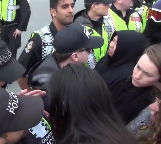 Salvation Army employee Jen Allan (black hoodie) pushes back and yells at VPD