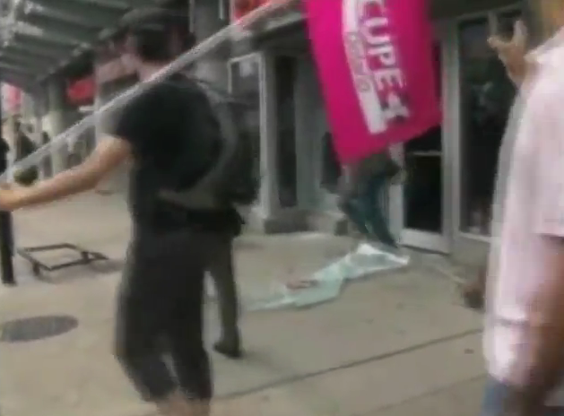 G20: This guy was smashing a Rogers store with his CUPE flagpole..
