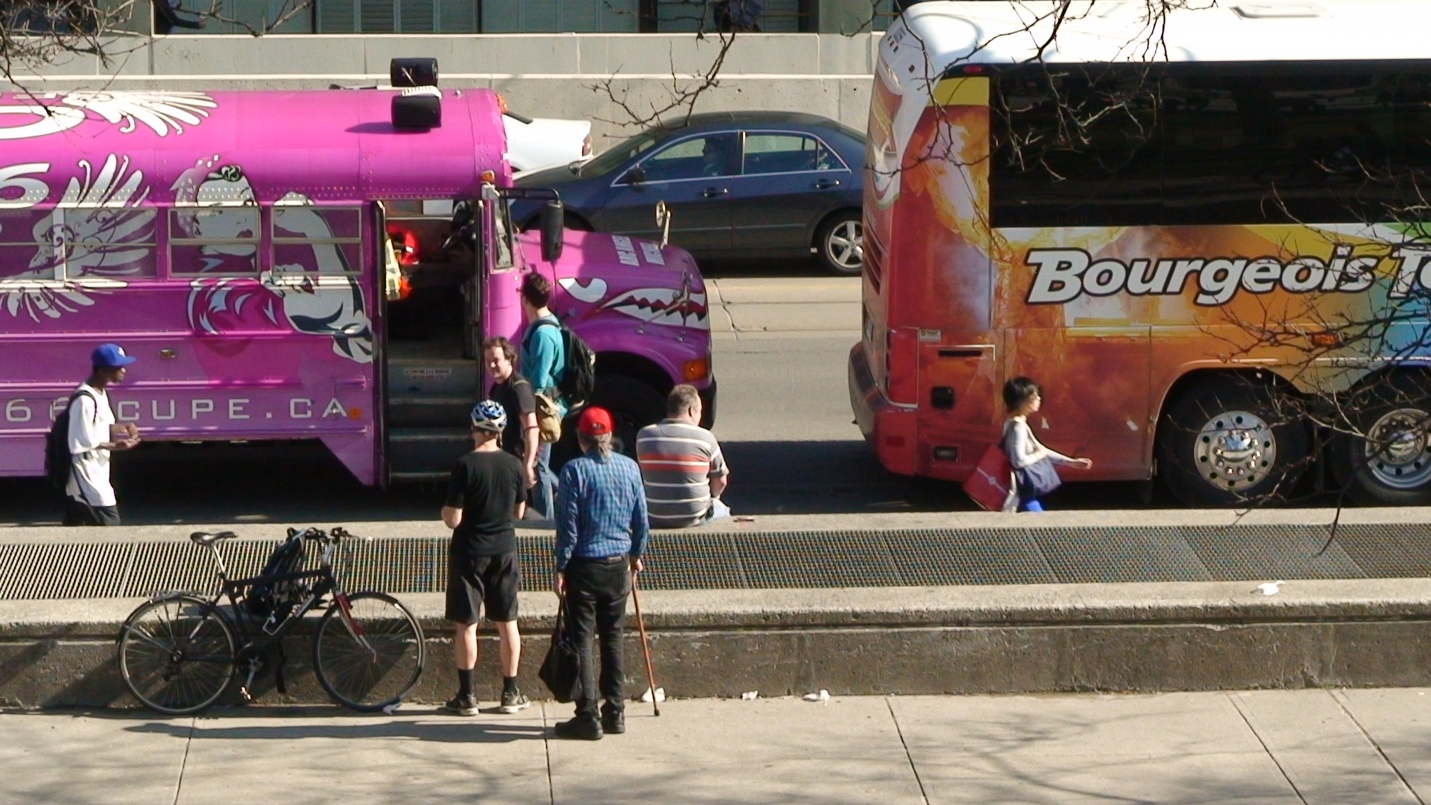 Anarchist leader Macdonald Scott beside two ironically placed buses...