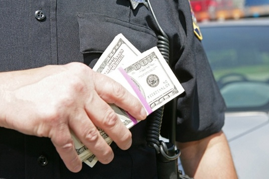 Officer lucky counting his May Day overtime...