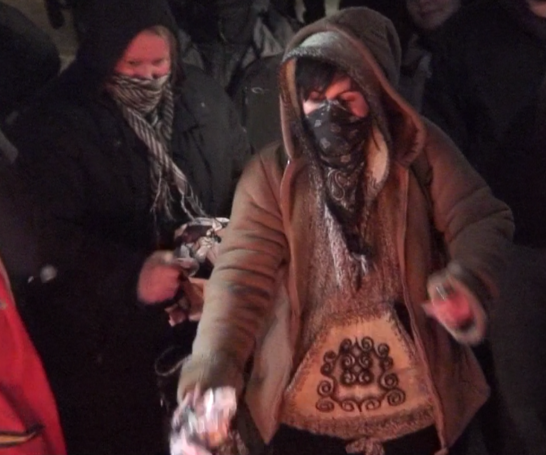 Swamp Line 9 arrestee Trish Mills & Sierra Club exec Chelsea Flook feeding a Queen St fire at a f##k the police rally...