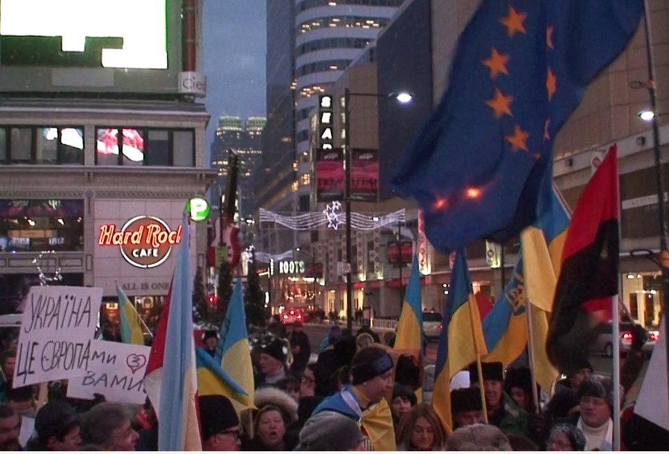 EU and XXX flags at Toronto's Dundas Square in December