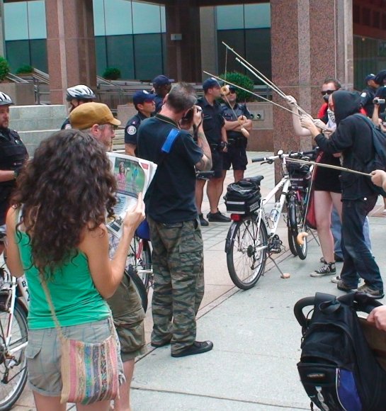 The Indignants go cop baiting in front of TPS headquarters...