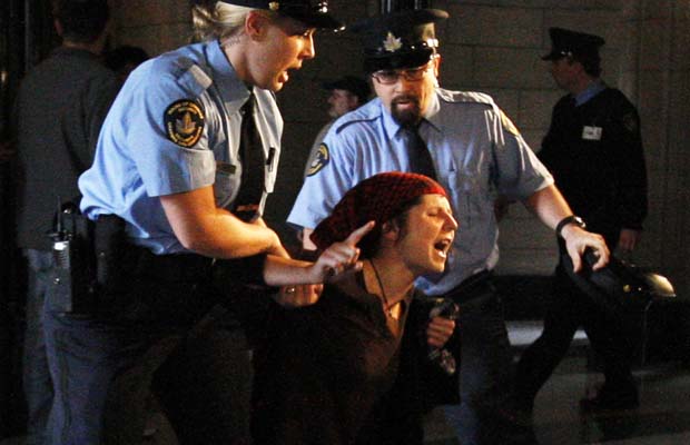 Chelsea Flook plays the role of a protester being brutally oppressed...