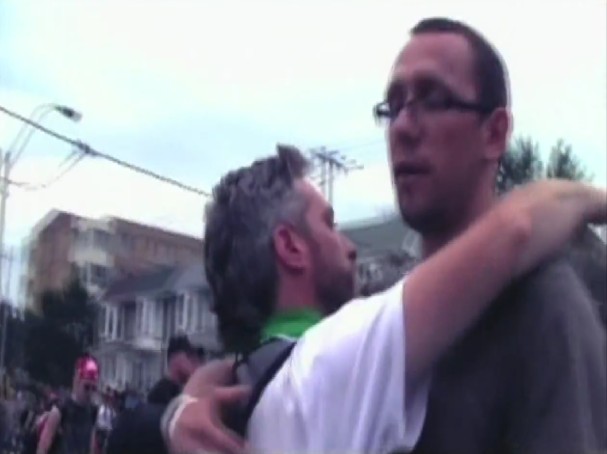 Dave Vasey (left) hugging Adam MacIssac as the later is being released from G20 detention centre