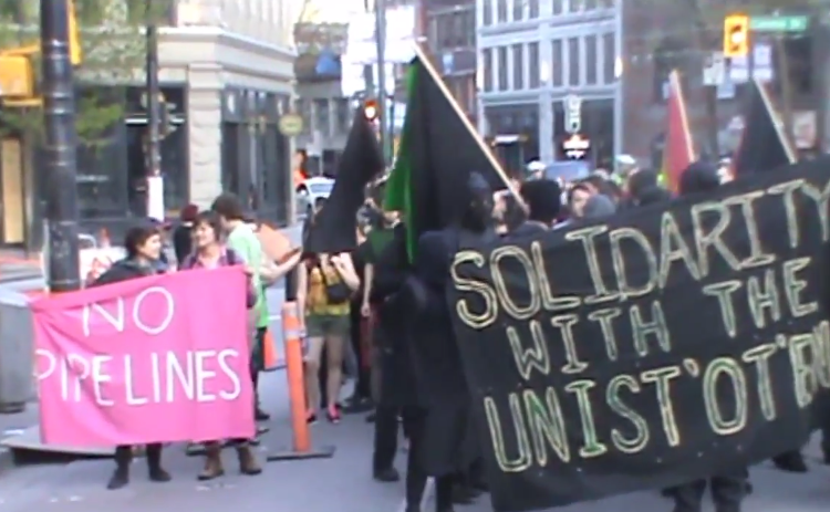 Masked up pipeline protesters on E. Hastings St.