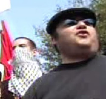 Andy Lehrer with a masked anarchist