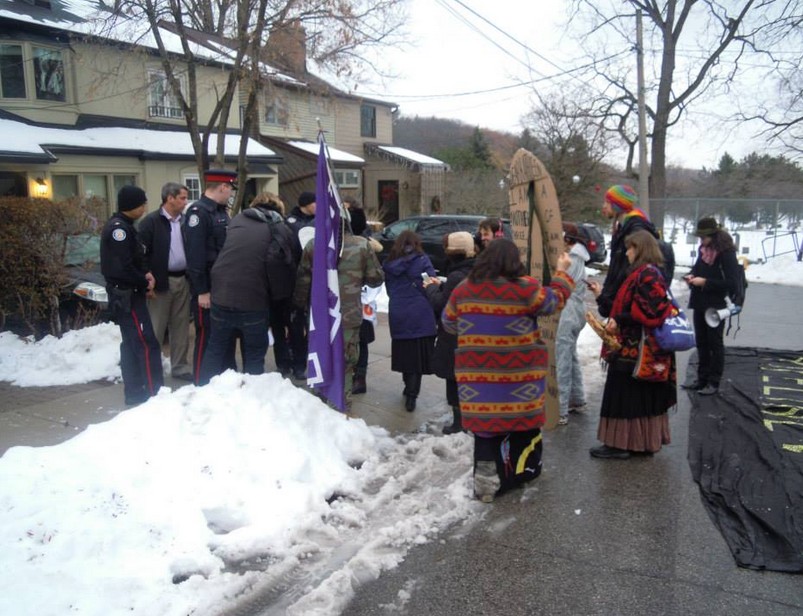 Miscreants blocked by the police from entering Wynne's driveway...