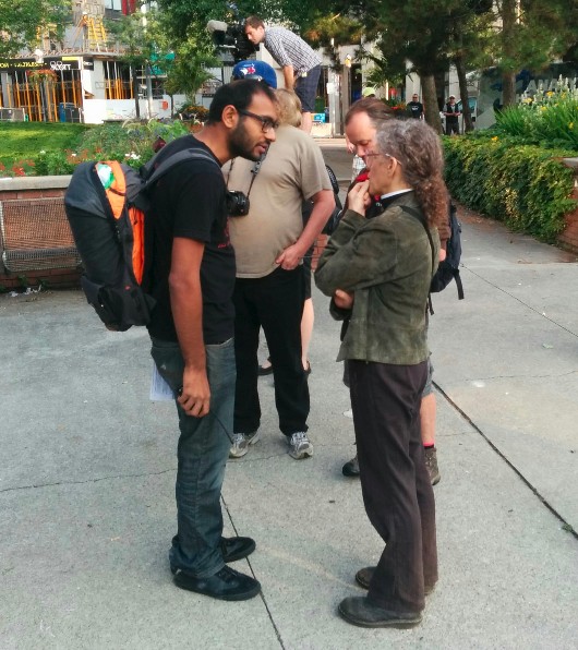 Anglican priest Maggie Helwig (right) beside Macdonald Scott (hidden) and Syed Hussan (left)