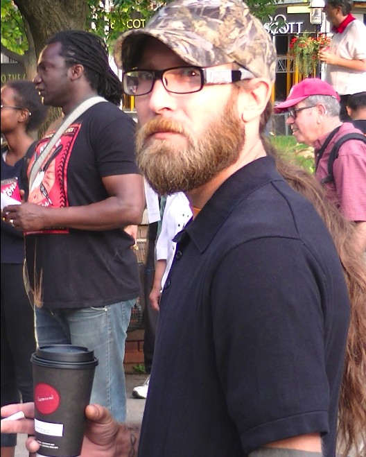 Anti-capitalist Alex Hundert "Lovin' It" with McDonalds coffee 